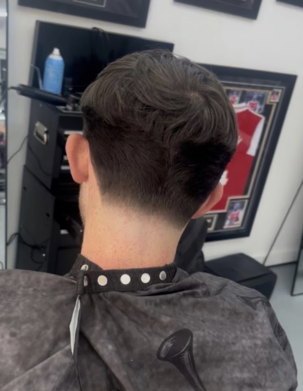 Textured haircut with a clean taper